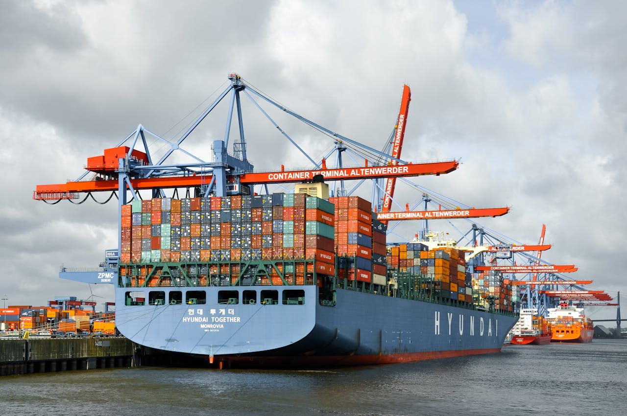 Large container ship docked at Hamburg port, showcasing global trade and logistics.