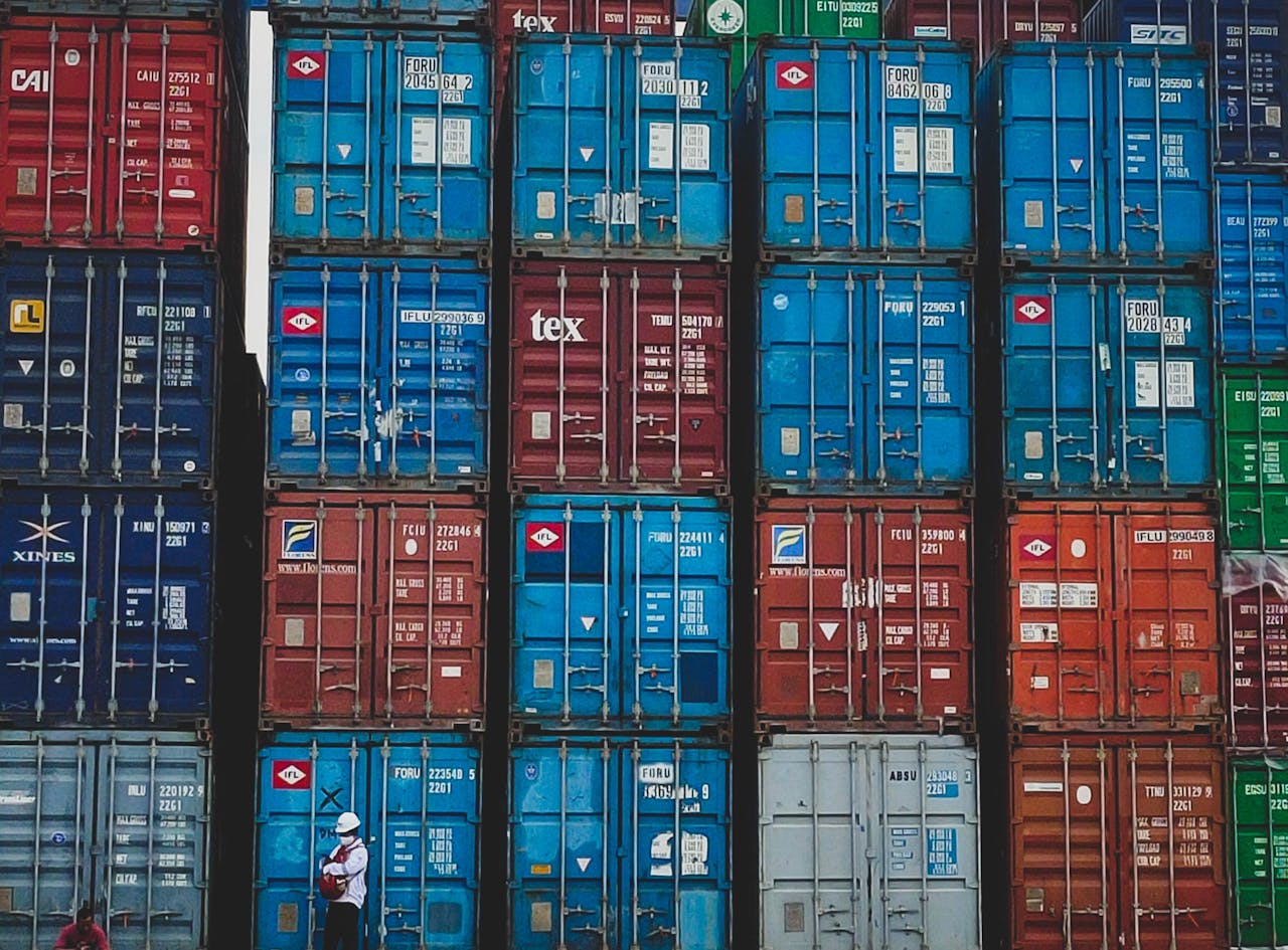 our-mission Colorful stacked cargo containers at a shipping yard in Jakarta, Indonesia.